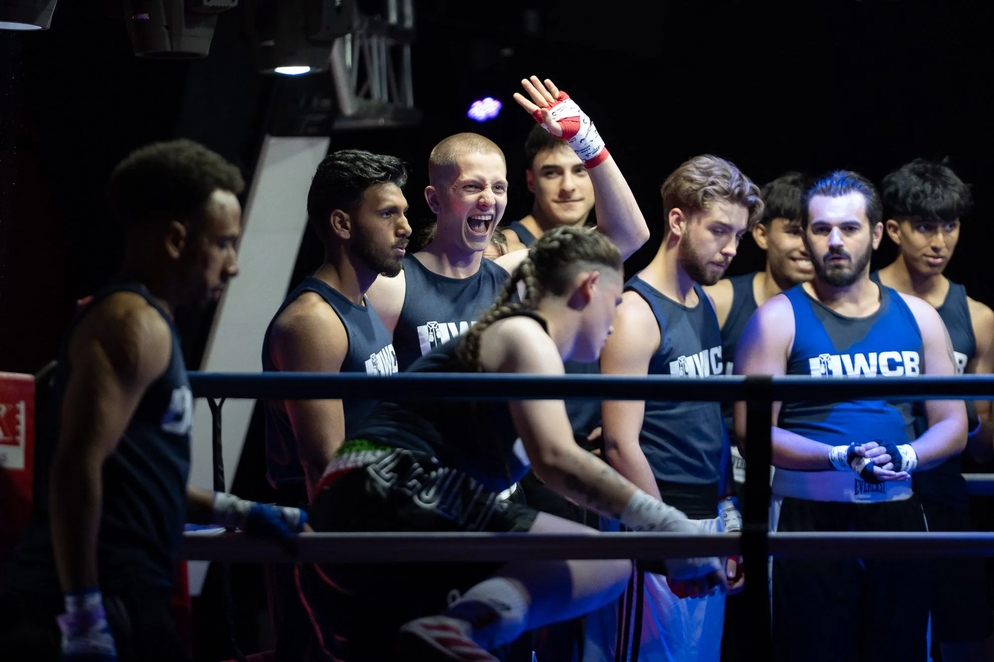 Young boxers gathered ringside at a community boxing club event, live event photography by Hector's Eye
