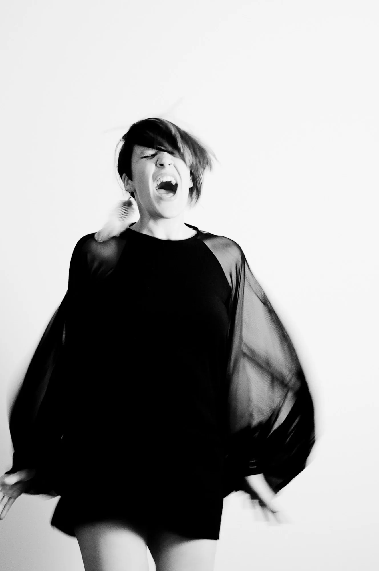 Dramatic black and white portrait of a performer captured mid-motion, portrait photography by Hector's Eye