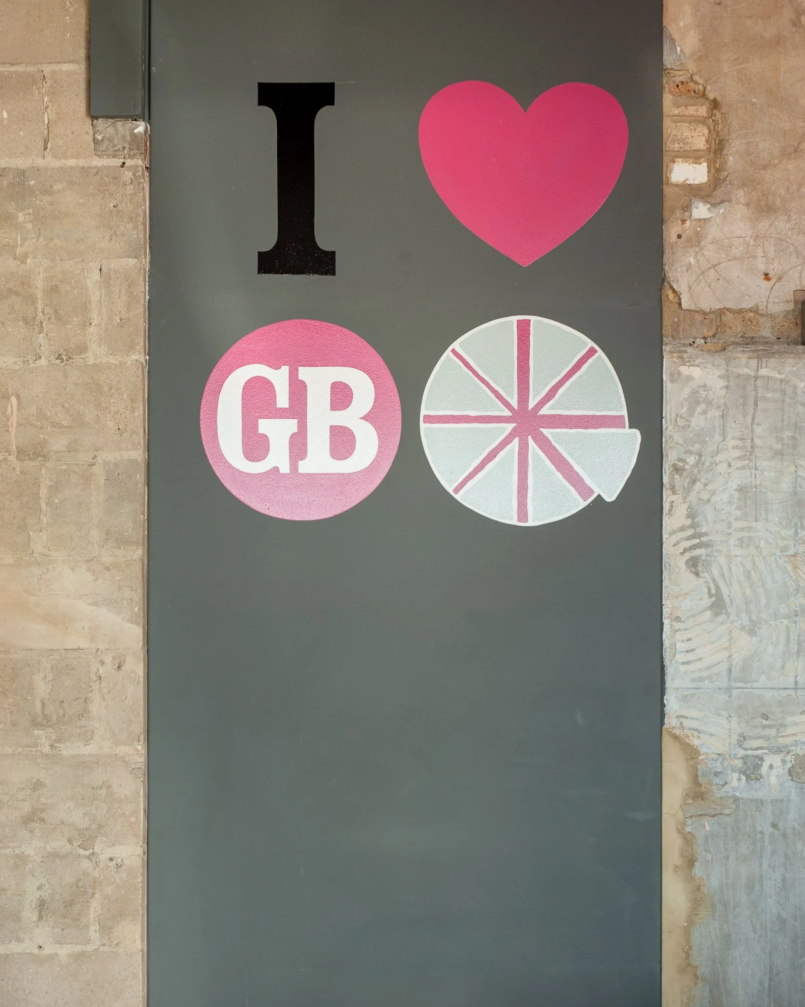 Detail of a hand-painted 'I love GB' mural on an exterior wall, brand storytelling photography by Hector's Eye