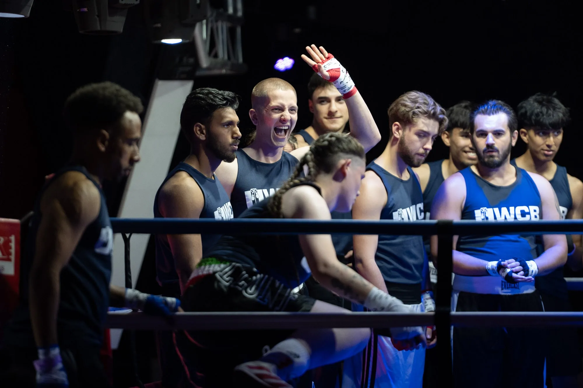 Amateur boxing club members celebrating ringside after a bout, live event photography by Hector's Eye
