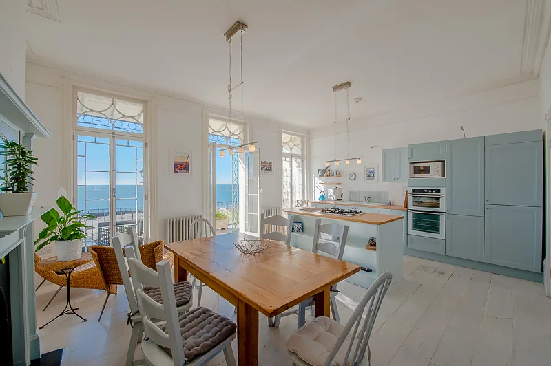 Bright coastal apartment interior with sea view, dining and kitchen area, brand storytelling photography by Hector's Eye for My Seaside Luxury