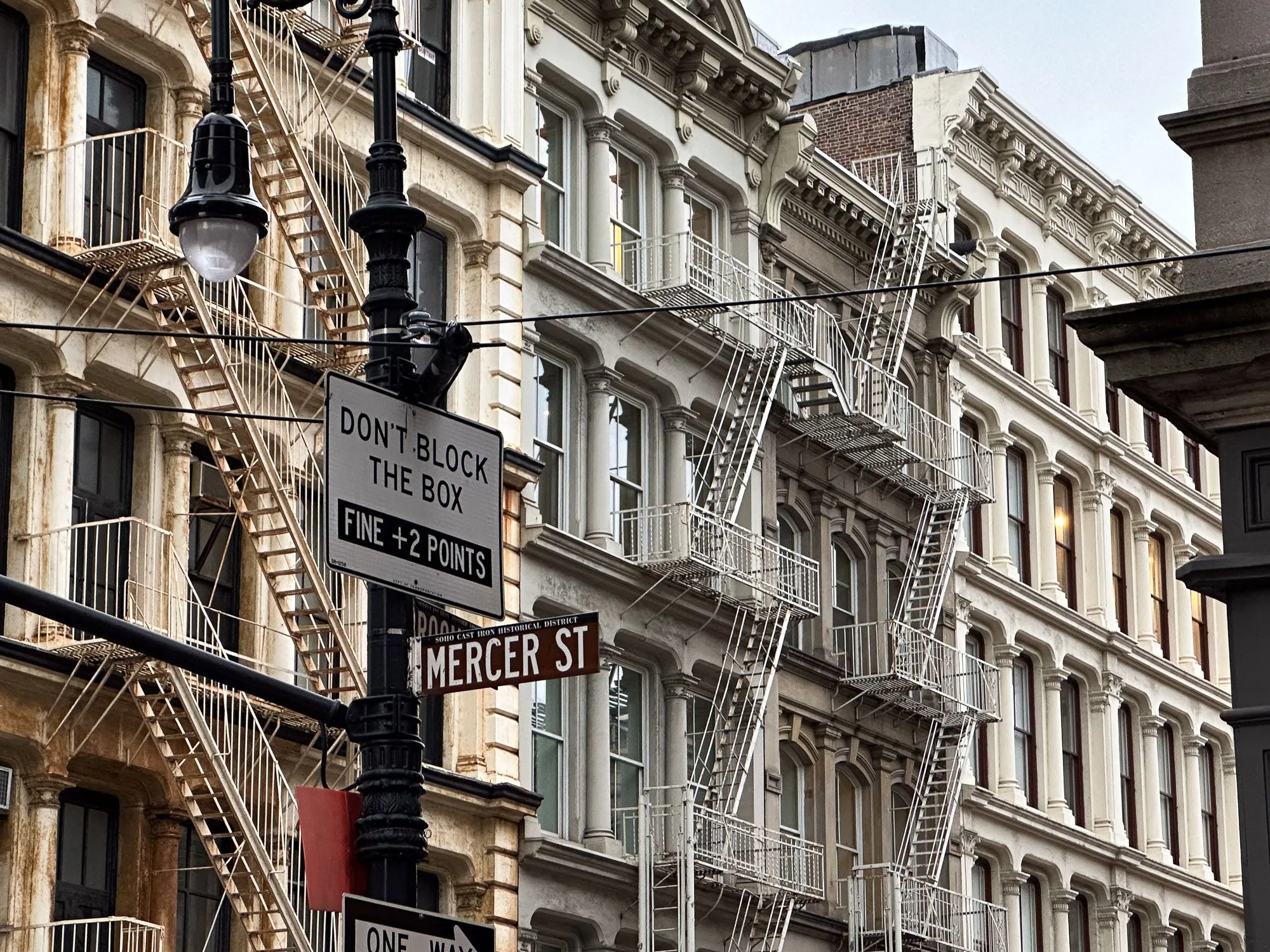 Cast-iron building facades with fire escapes on Mercer Street, street photography